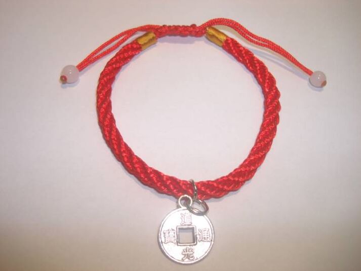 Red thread bracelet with rare coin to attract good luck